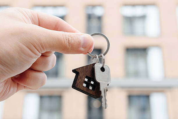 istock man hand with new apartment key 2244534639