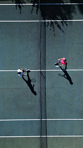 istock Aerial View of Tennis Match with Dynamic Shadows 2244535256