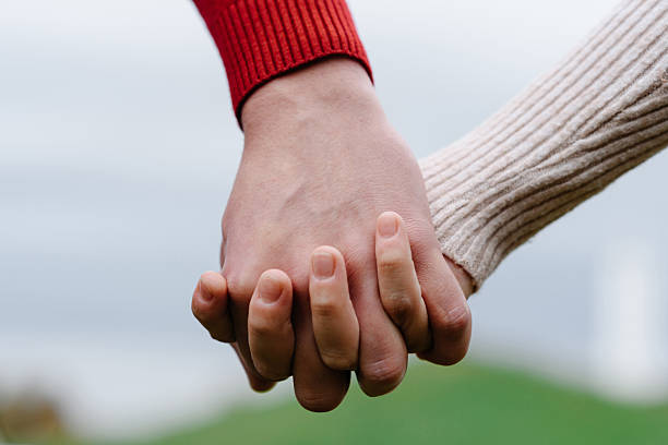 istock close-up view of couple holding hands 2244535257