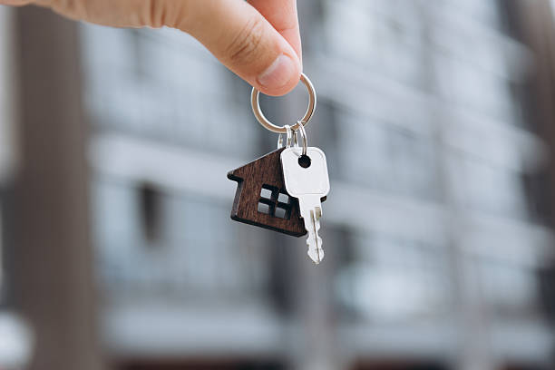 istock man hand with metal key 2244535264