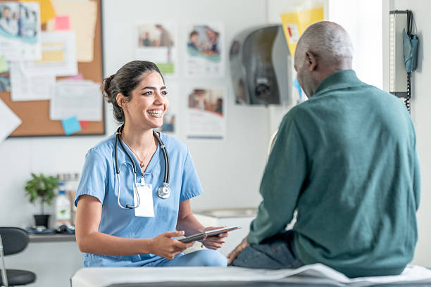 istock Compassionate Nurse Talks With Patient During Clinic Visit Using Tablet and Stethoscope 2244535519