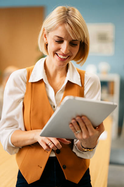istock Businesswoman looking at a digital tablet and smiling 2244535728