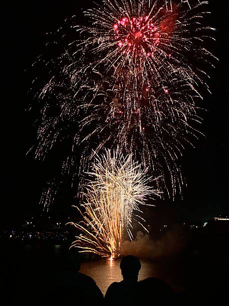 istock Fireworks lighting up the night sky above silhouetted crowd 2244537998