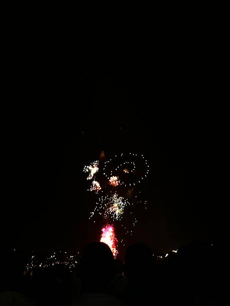 istock Fireworks lighting up the night sky above silhouetted crowd 2244538009