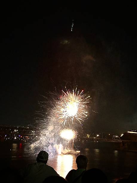 istock Fireworks lighting up the night sky above silhouetted crowd 2244538015