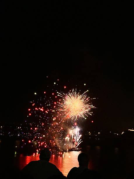 istock Fireworks lighting up the night sky above silhouetted crowd 2244538020