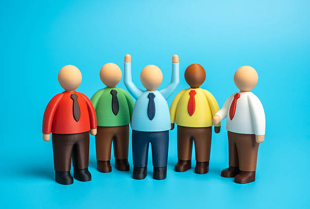 istock An employee accepts congratulations from colleagues on his promotion 2244540045