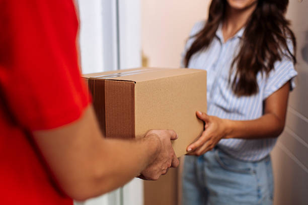 istock Delivery Moment: Customer Receives Package From Courteous Courier at Home Door 2244540778