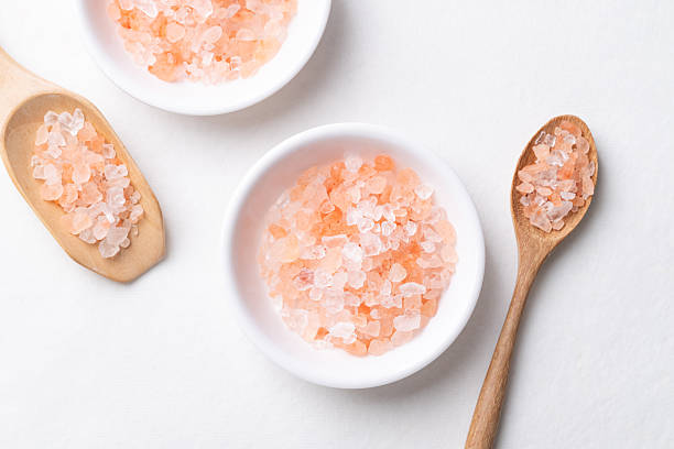 istock Himalayan pink salt in bowl with spoon on white background, Top view 2244547444