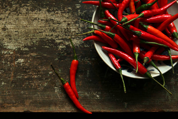 istock Fresh red chili peppers placed on a rustic wooden surface 2244555660