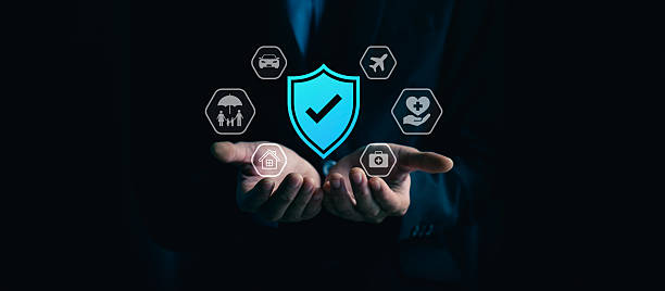 istock Comprehensive insurance protection and financial security concept with businessman hand holding shield check mark, of home, car, family, travel, health, medical care coverage for safety and stability 2244556307