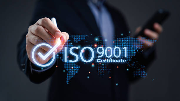 istock Businessman holding digital pen touching ISO 9001 certificate symbol representing quality assurance management standard certification and business excellence for global organization development. 2244567418