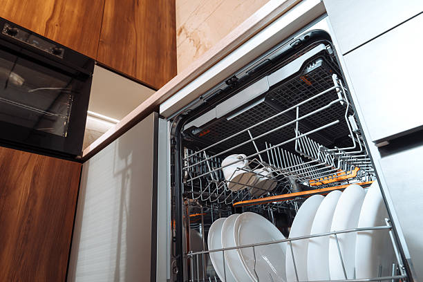 istock Open dishwasher machine loaded with dishes and utensils - interior, dishwasher, loaded, clean, kitchen. 2244567433