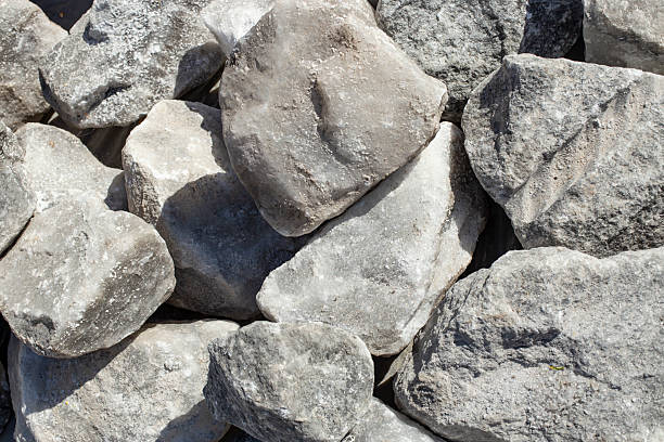 Big raw salt boulders piled in the sun light used for animals , full frame