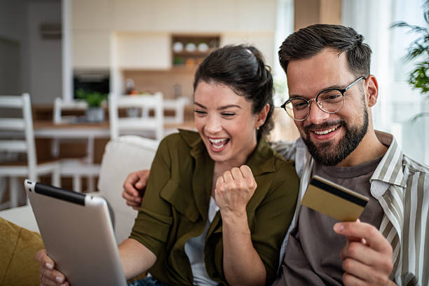 istock Happy couple online shopping using tablet and credit card 2244570105