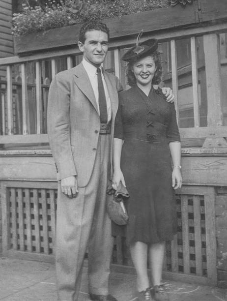 istock Young Couple Dressed Formally by Wooden House 2244571067