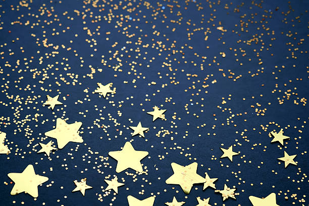 istock Abstract festive blue background with golden stars. 2244571109