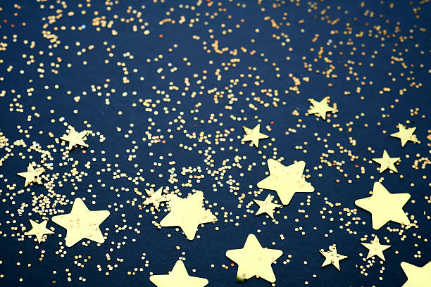 Abstract festive blue background with golden stars. High quality photo.
