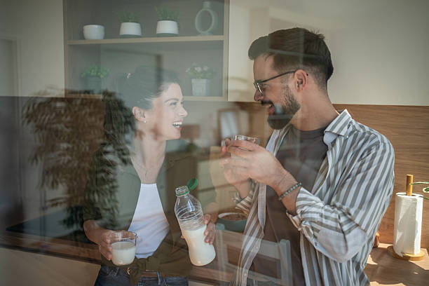 istock Happy couple enjoying morning breakfast and milk in kitchen 2244571340