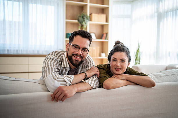 istock Happy couple relaxing together on a cozy sofa 2244573195