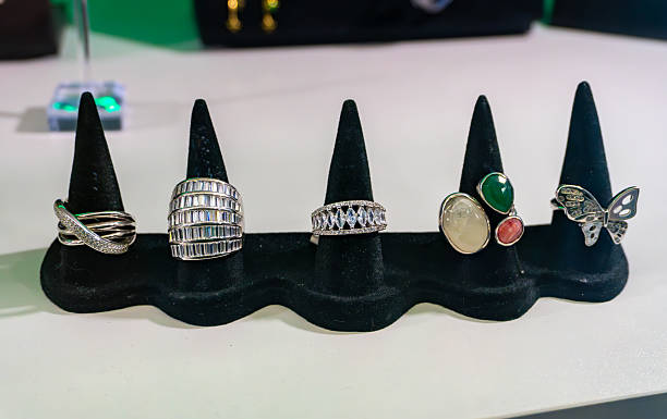 Rings displayed on jewelry stand in store window silver and decorative accessories elegant feminine fashion jewelry showcase presentation.