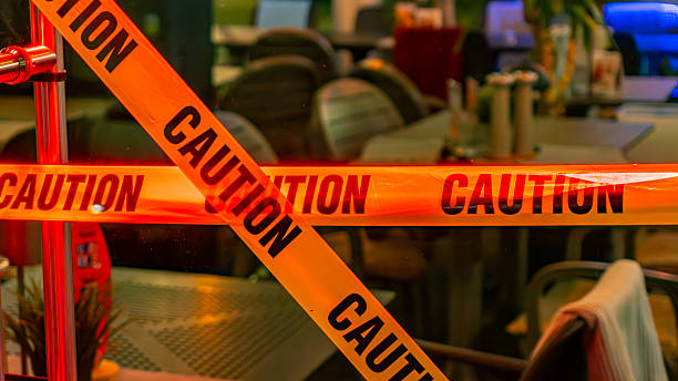 istock CAUTION warning tape in illuminated indoor space restricting access safety alert marking closed area interior scene with evening lighting. 2244573772