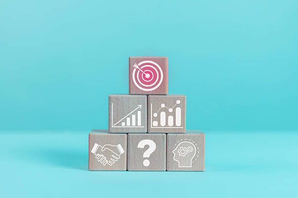 istock Wooden blocks with business icons such as target, chart, handshake, question mark, and head represent strategy, decision making, growth, teamwork, and goal achievement for business concept design. 2244574636