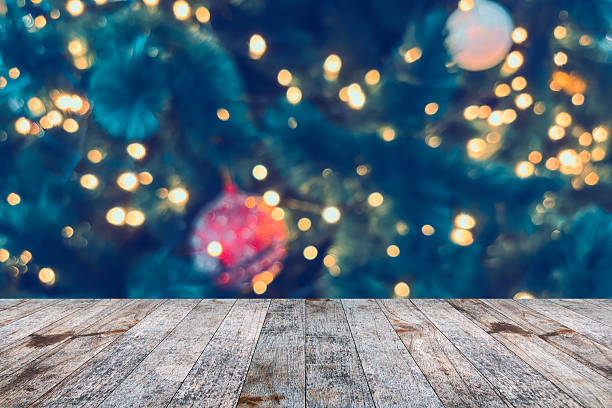 istock Empty wood table top with blur Christmas tree with bokeh light background 2244574687
