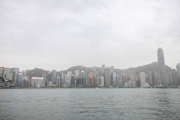 13 April 2025, Hong Kong.Hong Kong’s iconic skyline rises dramatically with its dense cluster of skyscrapers set against the surrounding hills. A faint haze lingers over the city, hinting at the ongoing challenge of air pollution that often softens the otherwise sharp urban vista.