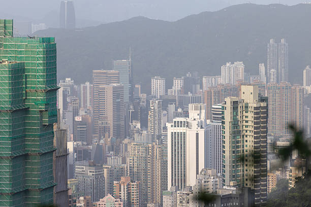 15 April 2025, Hong Kong.Hong Kong’s iconic skyline rises dramatically with its dense cluster of skyscrapers set against the surrounding hills. A faint haze lingers over the city, hinting at the ongoing challenge of air pollution that often softens the otherwise sharp urban vista.