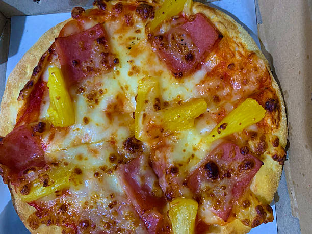 istock Hawaiian pizza with ham and cheese close up shot 2244575819