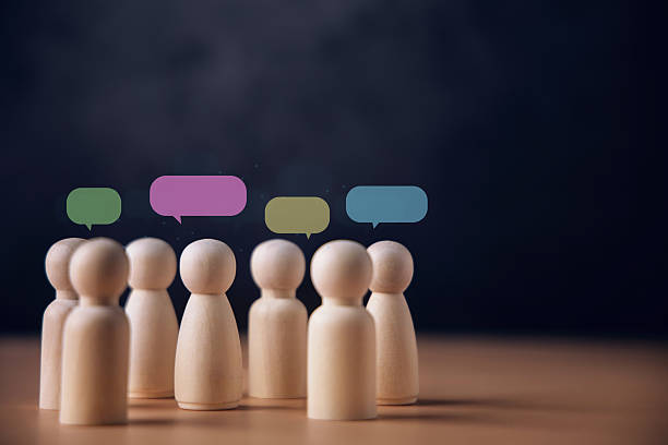 istock Wooden peg dolls with colorful speech bubbles, communication, Speak 2244575821