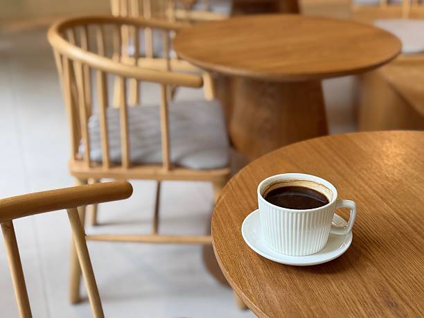 A cup of black coffee on wooden table