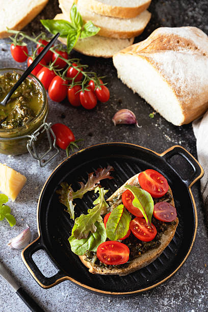 Fresh mediterranean bruschetta with cherry tomatoes and basil on grilled bread.