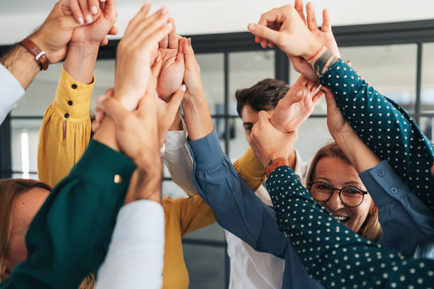 istock Business team raising hands, showing unity and motivation 2244579768