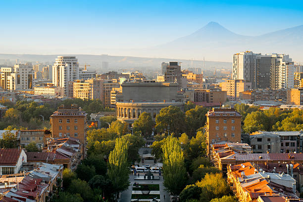Armenia Yerevan city view with a mountain in the background. The city is full of tall buildings and trees