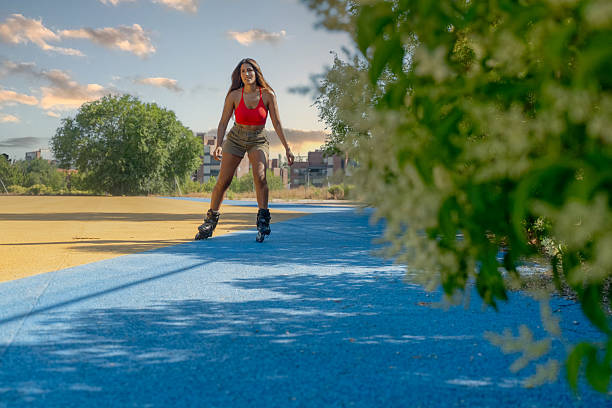 Young woman rollerblading outdoors, enjoying summer activity on a colorful track