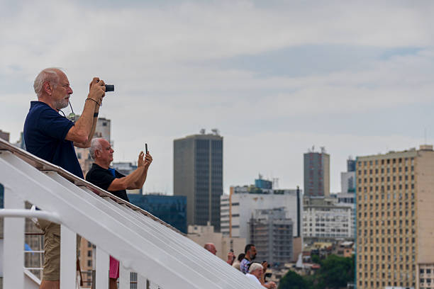 Rio de Janeiro Brazil on December 1, 2024. Tourists taking photos of Rio skyline  from a cruise ship docked  at the main cruise ship terminal Pier Maua located close to downtown .