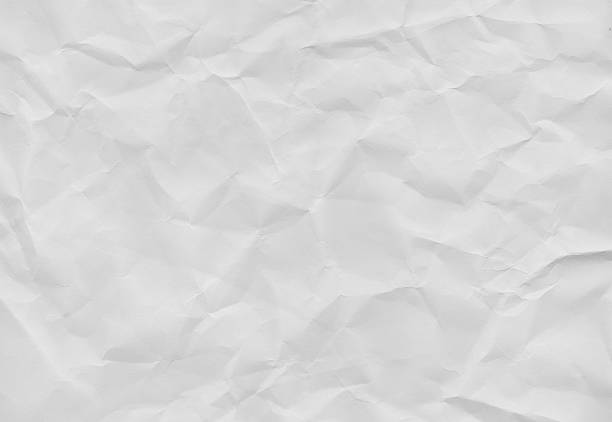 istock Crumpled white paper texture with soft shadows, ideal for backgrounds or design elements 2244582960