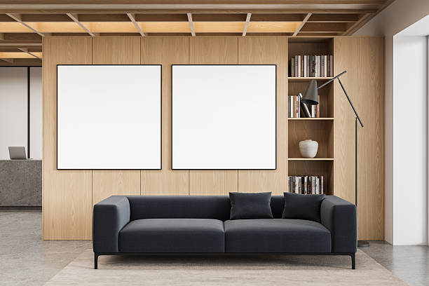 istock Modern living room interior with two square poster mockups above dark sofa, wooden panel wall and bookshelf concept design scene. 3D Rendering 2244586789