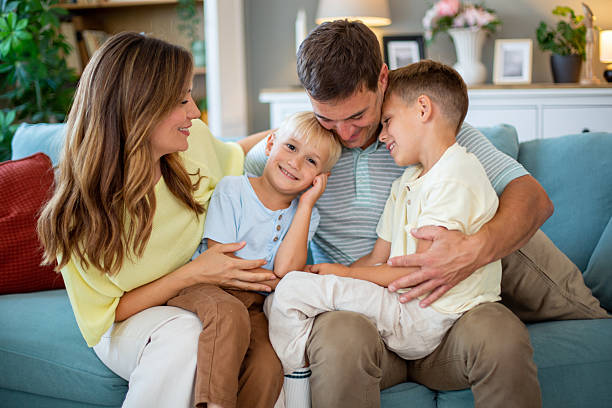 istock Happy family with two sons bonding on sofa 2244587805