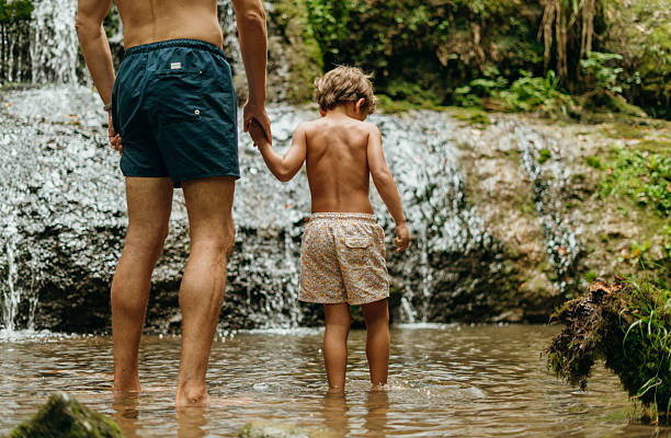 Father and son in the river