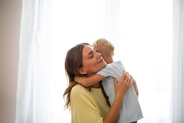 istock Mother embracing son with tender affection at home 2244589237