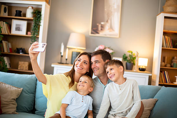 istock Family making selfie on sofa in living room 2244589287