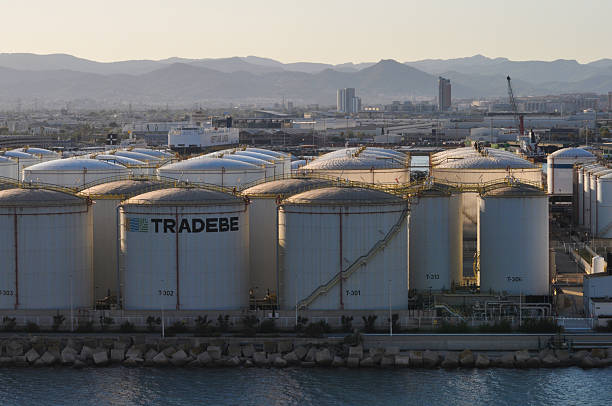 Barcelona, Spain - September 26, 2025: Tradebe oil tanks terminal in port under sundown light at Barcelona, Spain on September 26, 2025