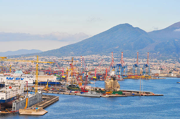Naples, Italy - September 22, 2025: Seaport with cargo ships, cranes, and industrial buildings at Naples, Italy on September 22, 2025