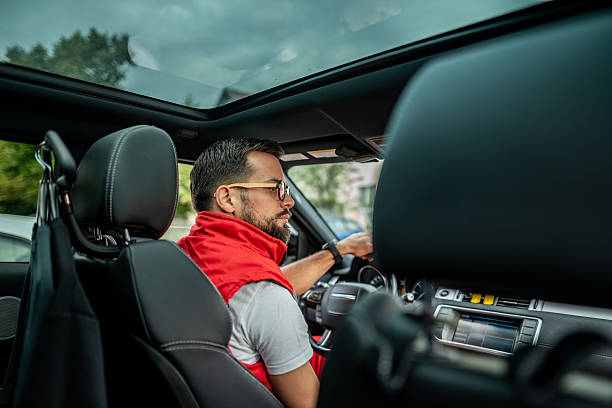istock Young adult man driving his modern car 2244592888