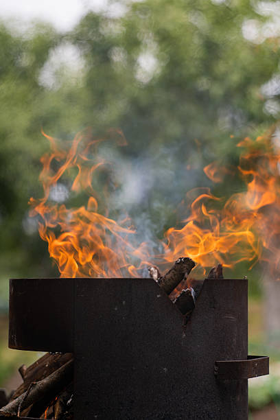 Burning firewood in the barbecue. Burning logs. A fire in the grill