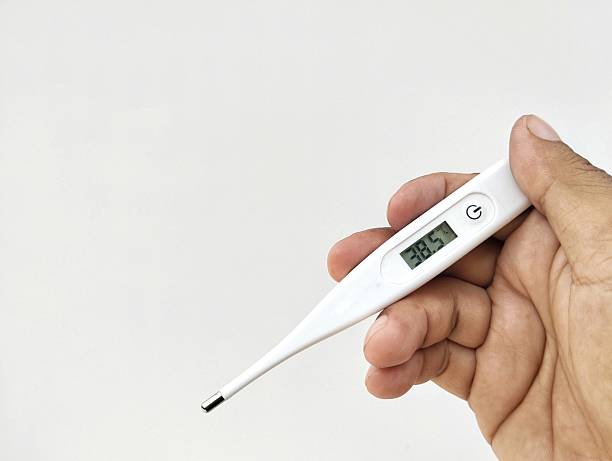 istock Hand holding a body temperature thermometer shows 38.5 degrees celcius on white background 2244597939