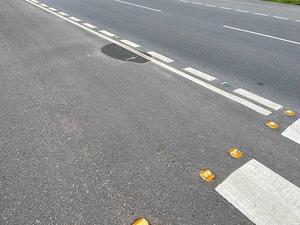 istock Road Lane Markings and Reflective Cat’s Eyes on Asphalt Highway 2244600513